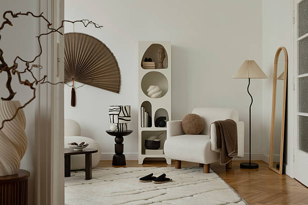 istock Stylish reading nook with soft textures and sculptural decor in warm neutrals. 2213897478