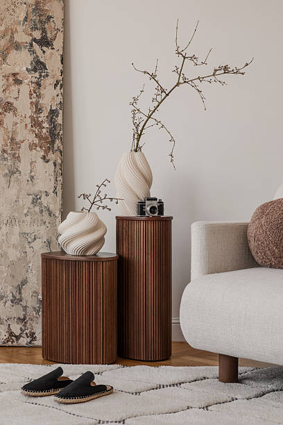 istock Cozy sofa with neutral cushions and blanket under a statement fan-shaped wall decor. 2213897528