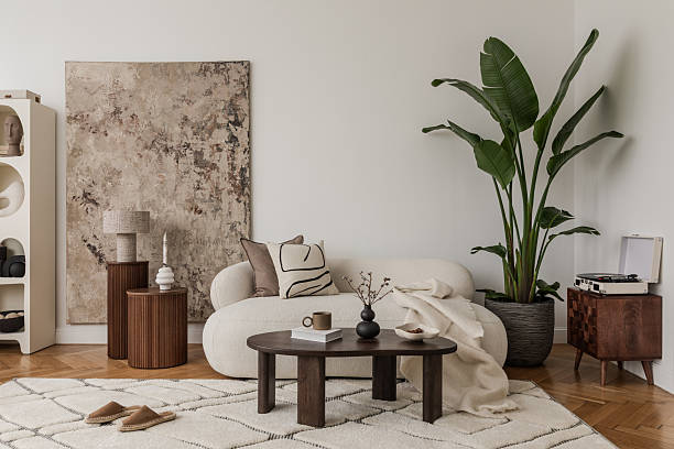 istock Open book and retro camera on a table in a soft-toned, modern lounge setting. 2213897549