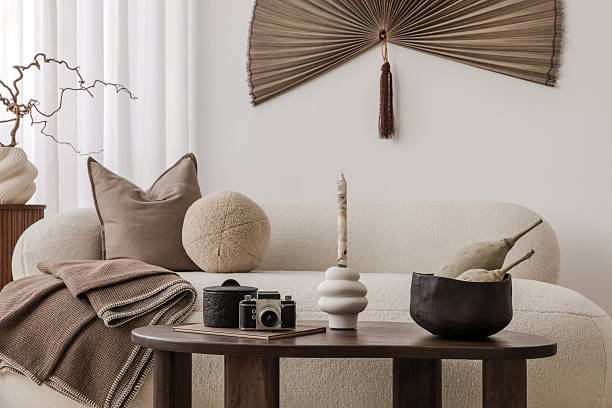 istock Stylish coffee table arrangement with sculptural candle, retro camera, and natural textures. 2213897771