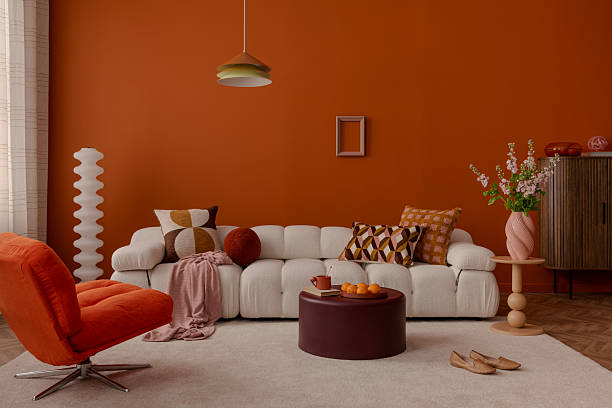 istock Modern interior with curved sofa and geometric cushions in warm tones. 2213899505