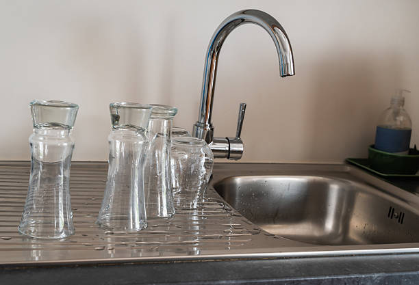 istock Stylish and Elegant Glasses Placed at a Modern Kitchen Sink for a Clean Look and Feel 2213899882