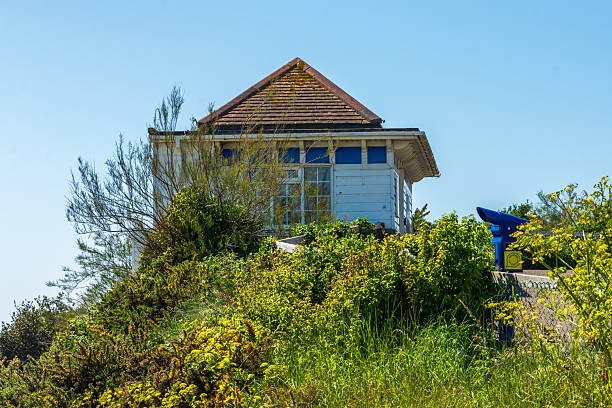 West Cliff Promenade, Bournemouth, UK - April 30th 2025: Blue telescope and the West Cliff Lift clifftop ticket office. The Lift is a funicular railway built in 1908.
