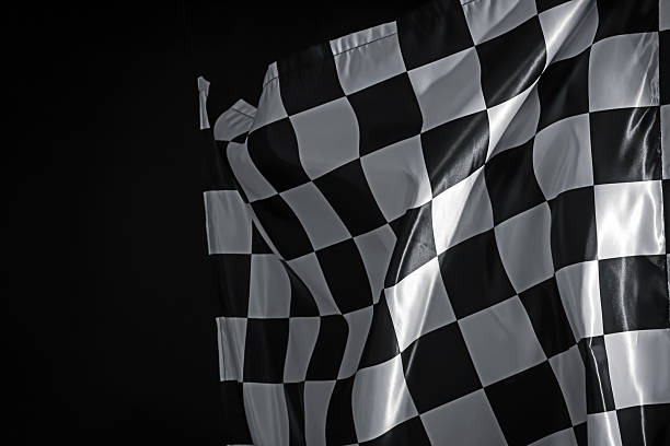 One racing checkered flag on black background, space for text
