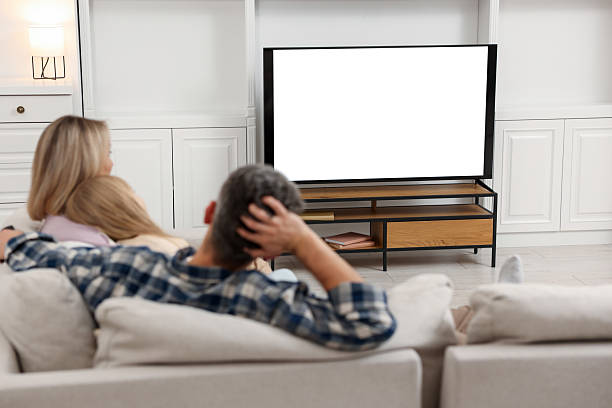 istock Family watching TV on sofa at home 2213901506
