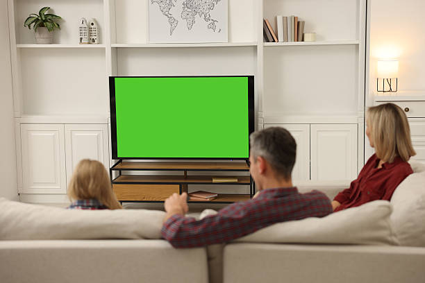 istock Family watching TV on sofa at home 2213901520