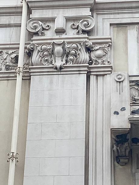 istock Decorative relief pillars on facade with garland 2213902489