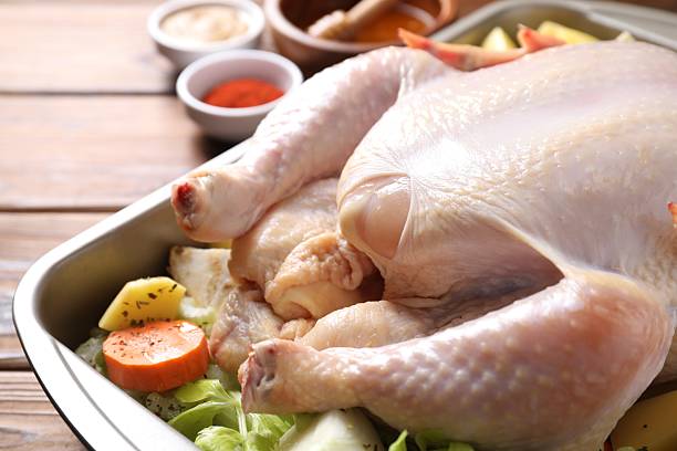 istock Raw turkey with different vegetables and spices on wooden table, closeup 2213904151