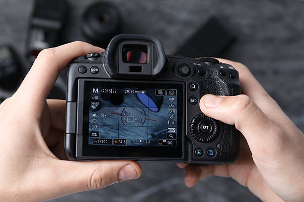 istock Photographer taking photo with professional camera in studio, top view 2213904278