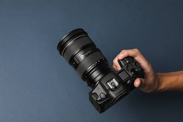 istock Photographer with professional camera on dark grey background, above view. Space for text 2213904316