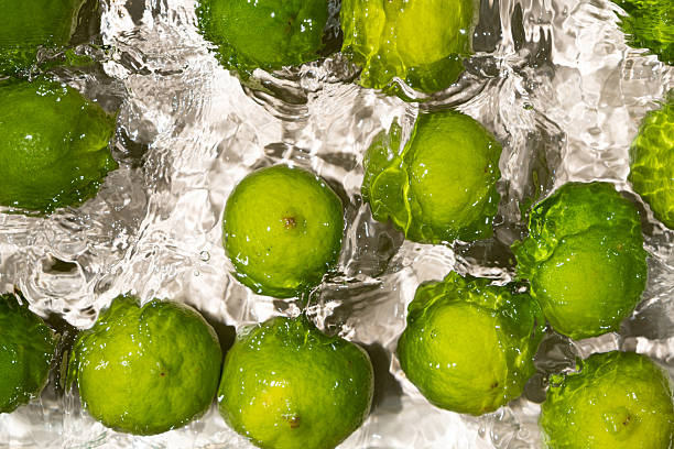 istock Fresh Whole Limes Floating in Water Top View 2213904979