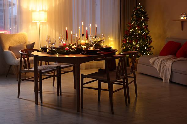 istock Festive table setting in room decorated for Christmas. Bokeh effect 2213904988