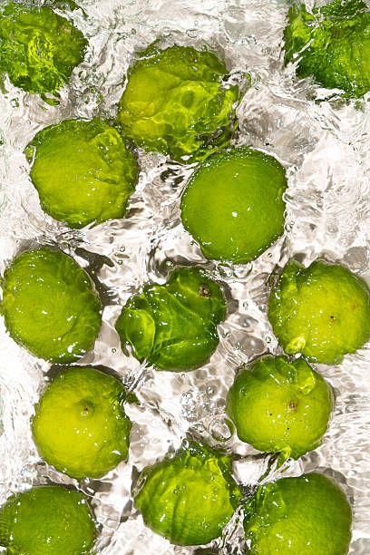 istock Vibrant Limes Submerged in Water Surface Scene 2213904996