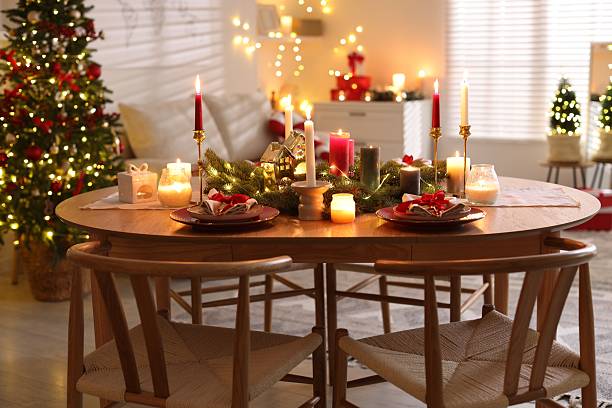 istock Festive table setting in room decorated for Christmas. Bokeh effect 2213905045