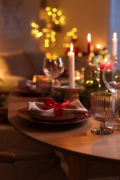 istock Festive table setting in room decorated for Christmas. Bokeh effect 2213905071