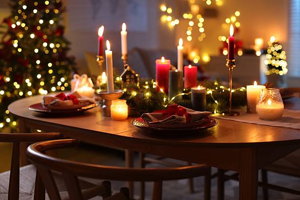 istock Festive table setting in room decorated for Christmas. Bokeh effect 2213905105
