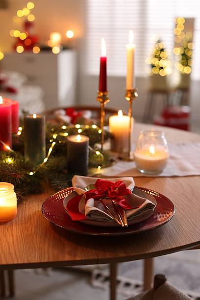 istock Festive table setting in room decorated for Christmas. Bokeh effect 2213905139