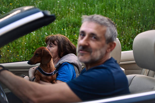 istock married couple in a convertible 2213905351