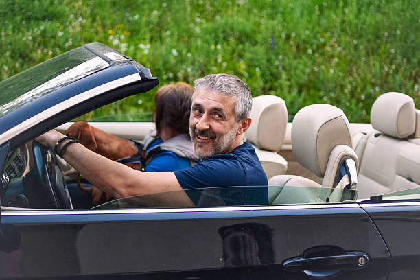 istock married couple in a convertible 2213905366
