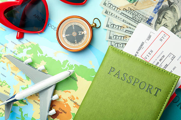 istock Passport with tickets, map, compass, plane model, money and sunglasses on light blue background, flat lay 2213905398