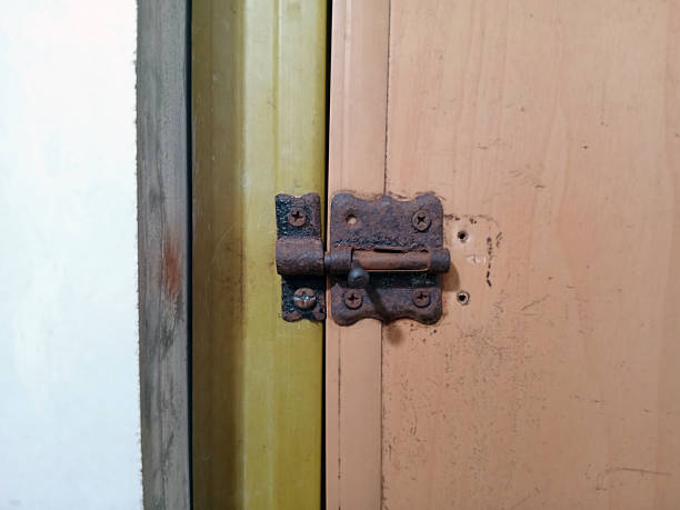 istock Rusty Door Bolt on a Painted Wooden Door 2213907671