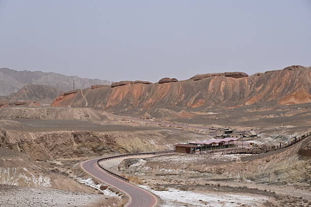 istock Zhangye's rainbow-colored Danxia landforms paint a surreal geological masterpiece, with layered hues of red, gold and blue under dramatic desert skies. 2213908041