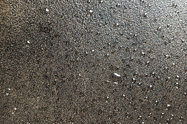 Water droplets on a cast iron macro surface. Cast iron cookware care, rust resistant, abstract pattern.