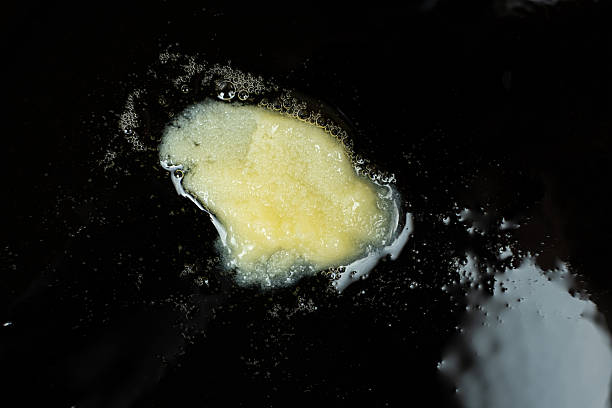 istock Ghee clarified butter melts in a cast iron skillet, cooking. 2213908761