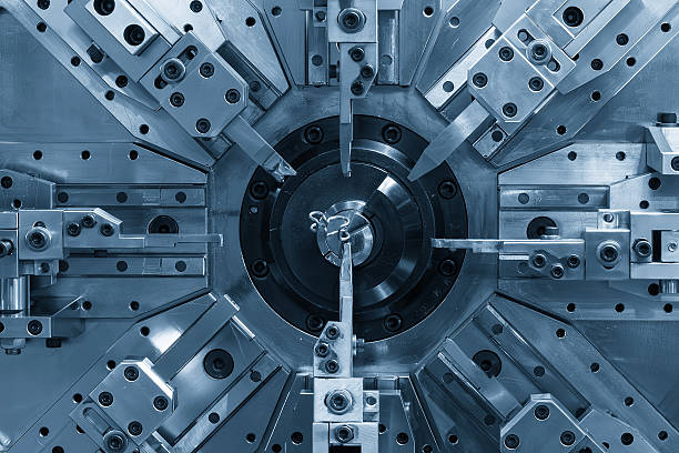 istock Close up the wire coil spring making machine in light blue scene. 2213909175