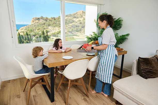 Mother Serving Breakfast to Children in a Bright Modern Dining Room