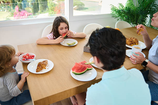 istock Family Enjoying Breakfast Together in a Bright and Modern Setting 2213910207