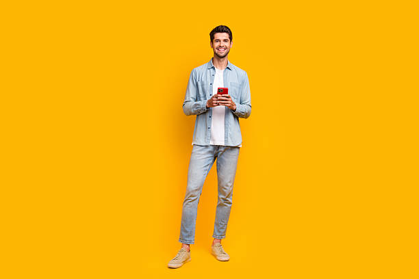 istock Photo of millennial guy using modern technology typing email on website instagram isolated bright color background 2213911806