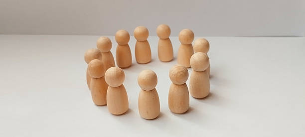 istock Collaborative group discussion with wooden figures minimalist studio setting focus on interaction creative concept 2213912037