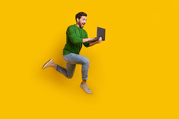 istock Full size body photo of young crazy business worker web developer professional programmer running jump isolated on yellow color background 2213913061