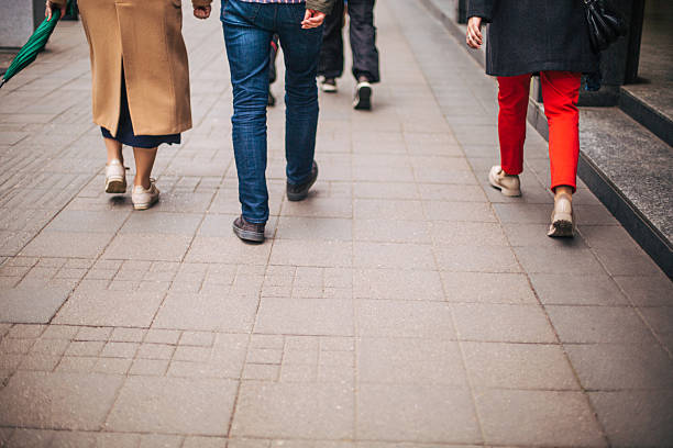 istock Group of people walking on a sidewalk 2213923537