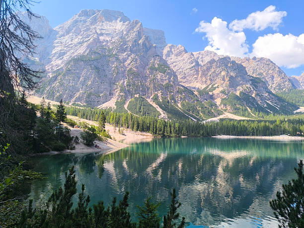 istock Majestic alpine scene showcasing a tranquil lake reflecting towering mountains during a sunny day 2213925968