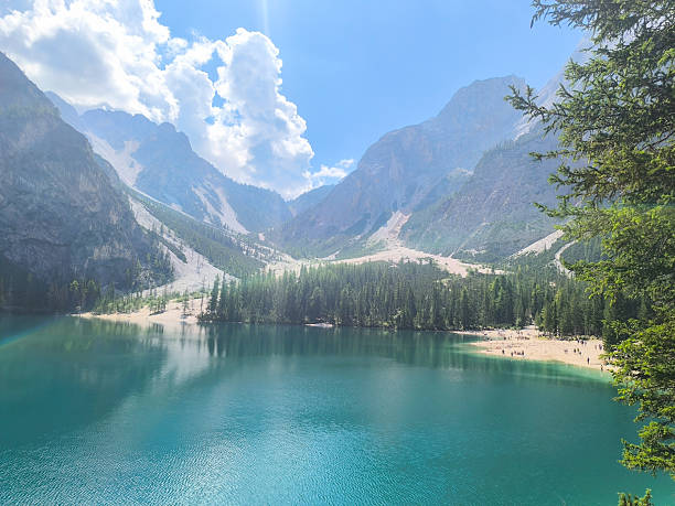 istock Majestic reflections on a serene mountain lake surrounded by lush greenery under a bright blue sky 2213925988