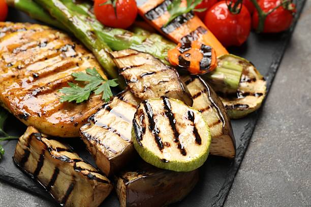 istock Delicious grilled vegetables and chicken breast on grey table, closeup 2213928162