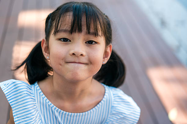istock Thoughtful Young Girl Making Cute Expression Outdoors 2213929800
