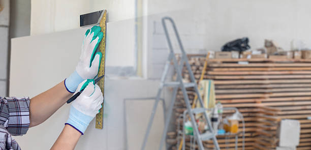istock Measuring and marking a wall for installation in a workshop . 2213930298