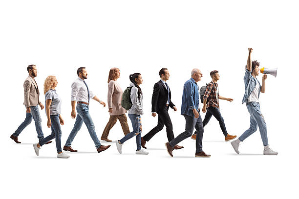 istock Group of people follwing a young man with a megaphone on a protest 2213933549