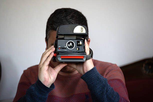 Handsome man with instant camera