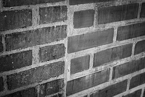 abstract weathered red orange rustic bi-section brick wall grunge monochrome background