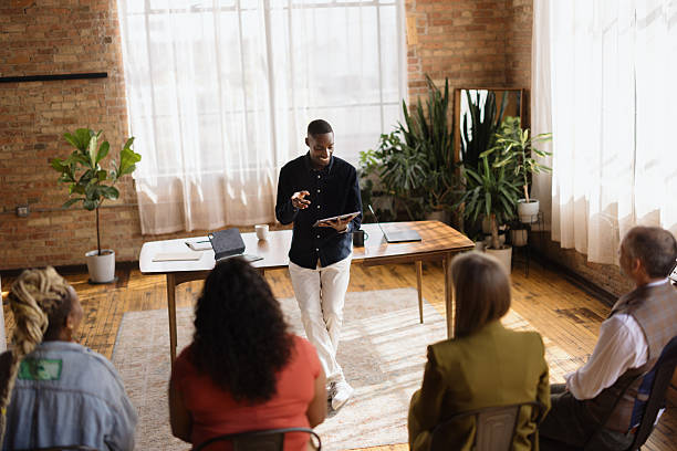istock Young businessman leading a meeting using a tablet in a modern office 2213936218