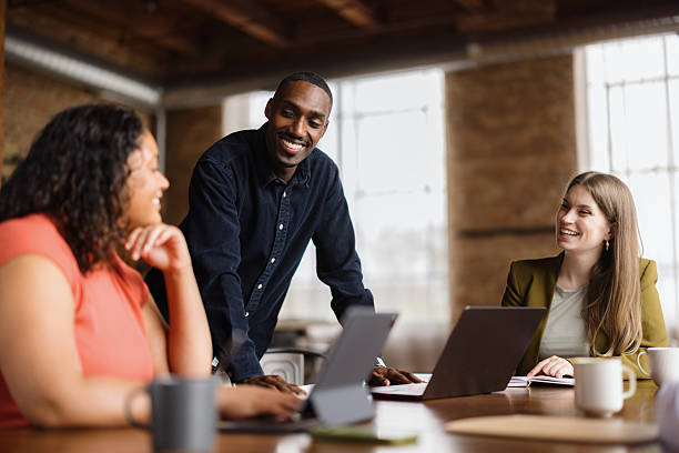 istock Young business team collaborating on a project using laptops and tablets in a modern office 2213936226