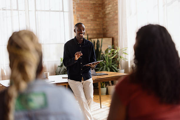 istock Young businessman leading a meeting with his team using a tablet 2213936230