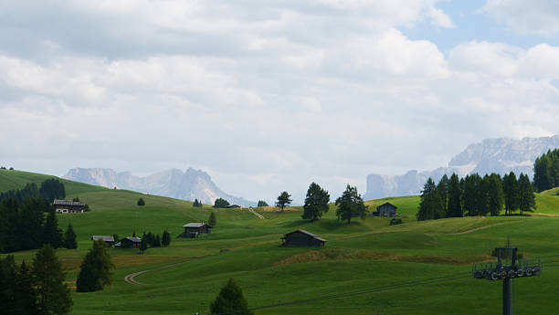 istock Vast green meadows and distant mountains under a cloudy sky in the stunning Dolomites of northern Italy 2213938544