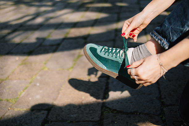 istock Unrecognizable woman tying shoelaces on sneakers 2213938596