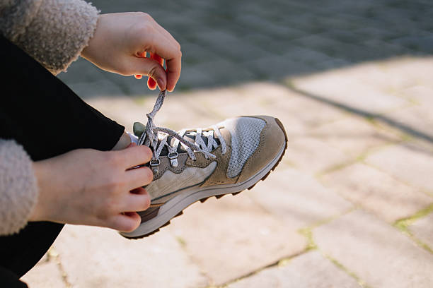 istock Unrecognizable woman tying shoelaces on sneakers 2213938604