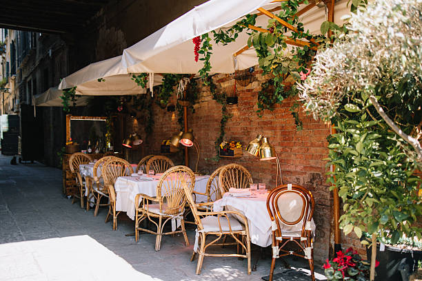 istock Cozy street with terrace tables and chairs 2213938796